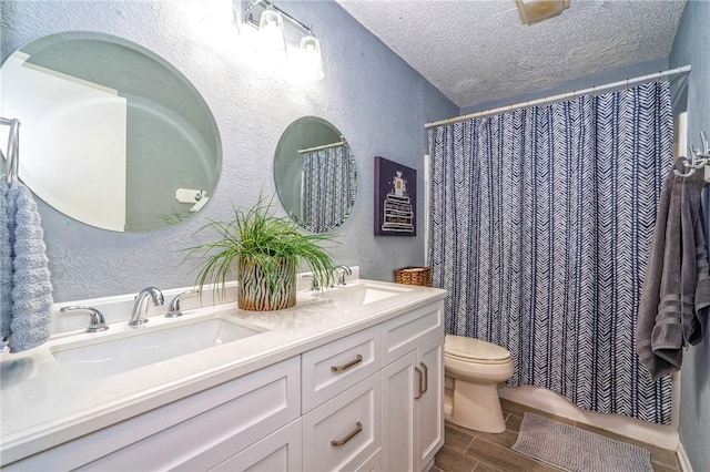 4318 Pecan Bayou Ct, Corpus Christi, TX 78410 - bathroom featuring vanity, a textured ceiling, and toilet