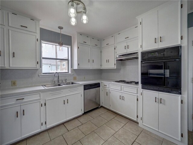 kitchen featuring black oven, stainless steel dishwasher, a sink, under cabinet range hood, and electric cooktop