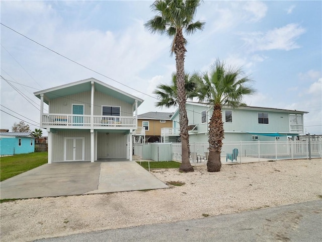 beach home with fence and driveway