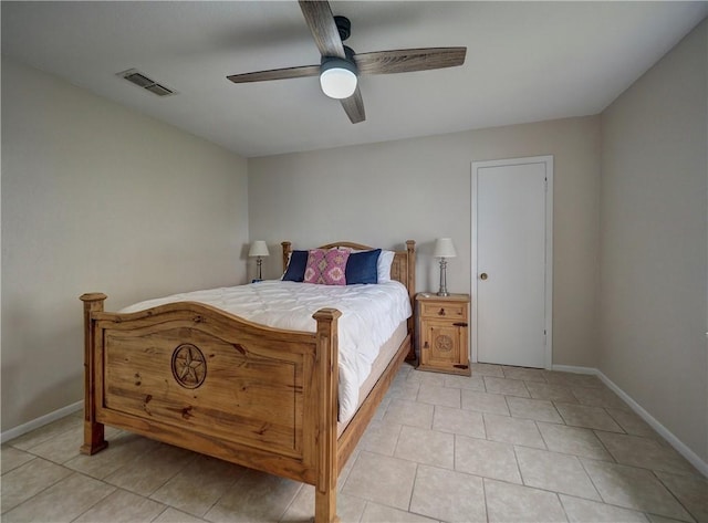 bedroom featuring baseboards, light tile patterned flooring, and a ceiling fan