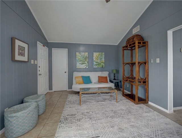 living area featuring vaulted ceiling, light tile patterned floors, ornamental molding, and wood walls