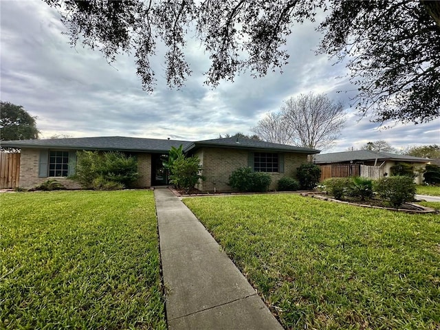 ranch-style home with a front lawn