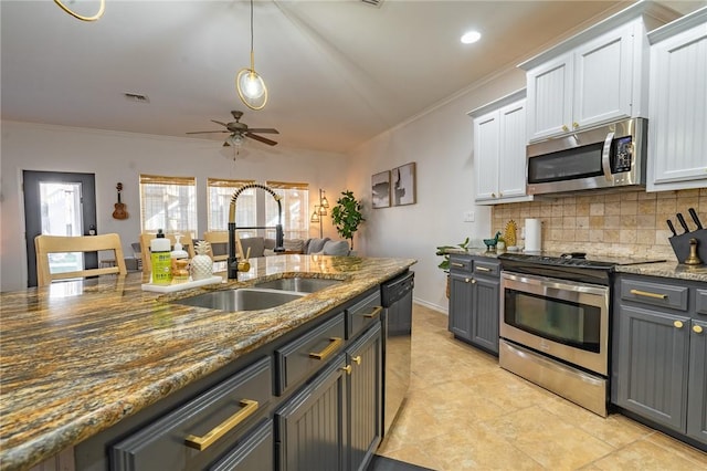 14878 Granada Dr Unit 403, Corpus Christi, TX 78418 - kitchen featuring crown molding, decorative backsplash, a ceiling fan, and appliances with stainless steel finishes
