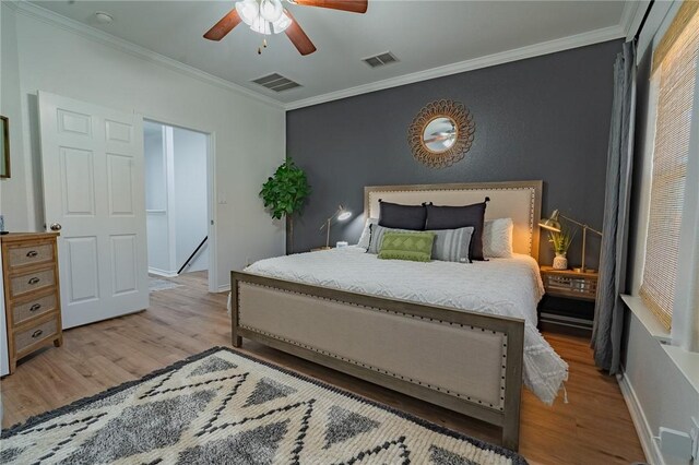 14878 Granada Dr Unit 403, Corpus Christi, TX 78418 - bedroom featuring crown molding, visible vents, light wood-style flooring, and baseboards