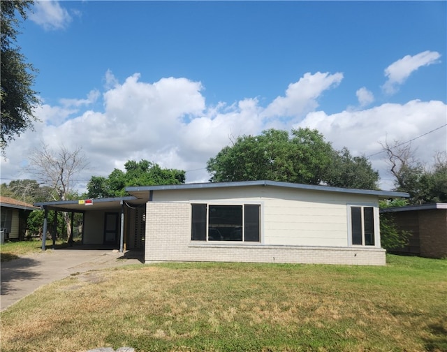 view of front facade with a front lawn and a carport