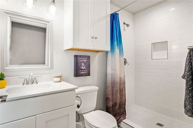 bathroom with vanity, a shower with shower curtain, and toilet