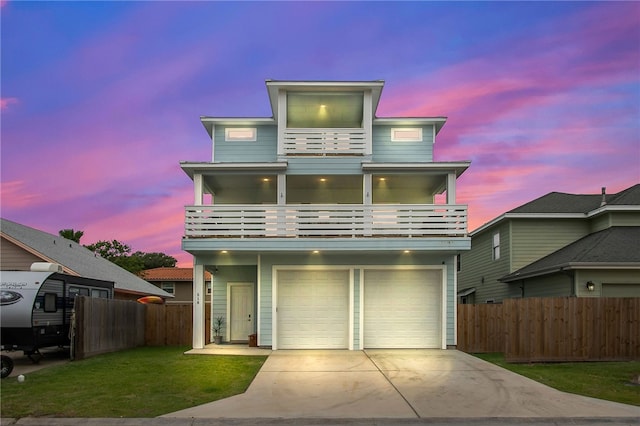 view of front of property with a garage, a balcony, and a yard