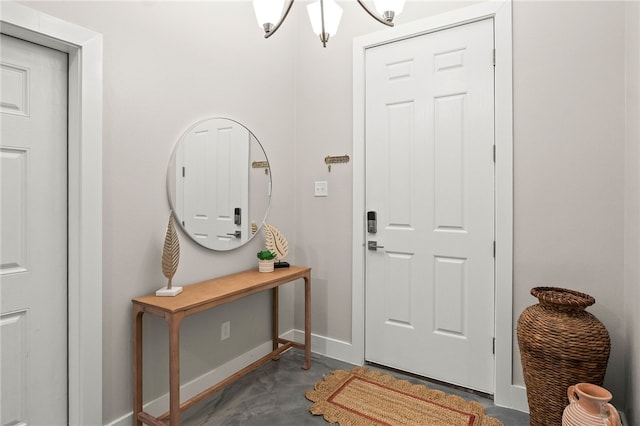 entryway with a chandelier