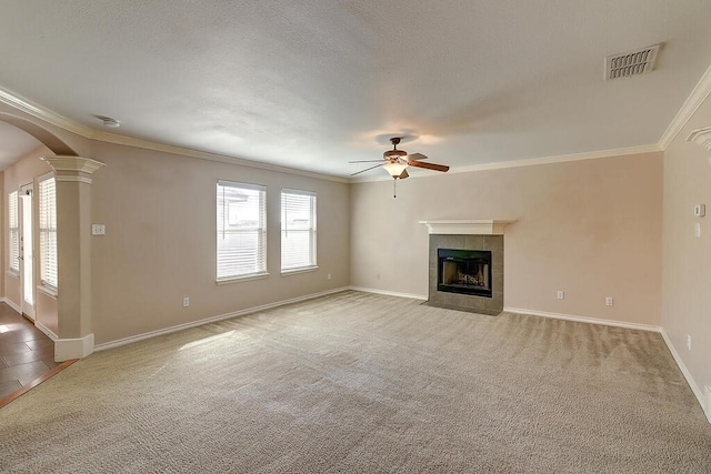 2334 Mystic Star Dr, Corpus Christi, TX 78414 - unfurnished living room featuring a ceiling fan, healthy amount of natural light, a tile fireplace, light carpet, and ornamental molding