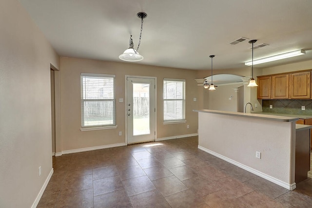 2334 Mystic Star Dr, Corpus Christi, TX 78414 - kitchen featuring decorative backsplash, a ceiling fan, light countertops, pendant lighting, and a peninsula