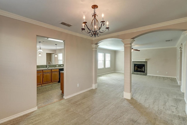 2334 Mystic Star Dr, Corpus Christi, TX 78414 - unfurnished living room with light carpet, arched walkways, ornate columns, crown molding, and a fireplace