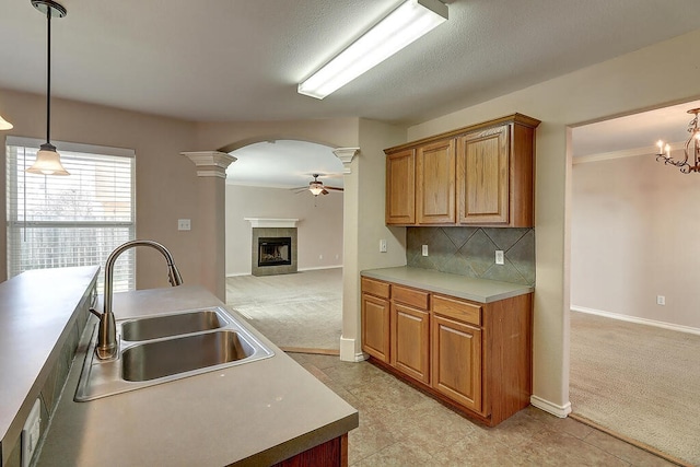 2334 Mystic Star Dr, Corpus Christi, TX 78414 - kitchen featuring a ceiling fan, a tile fireplace, light carpet, arched walkways, and open floor plan