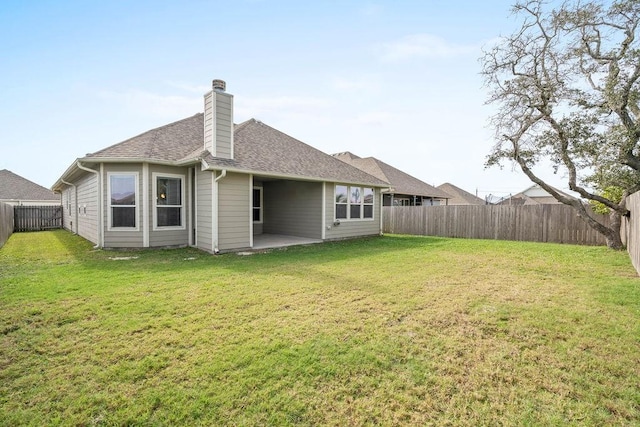 rear view of property featuring a patio and a lawn