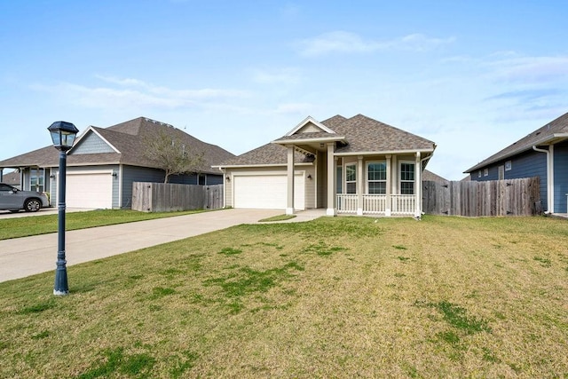 ranch-style house with a front yard, a garage, and covered porch