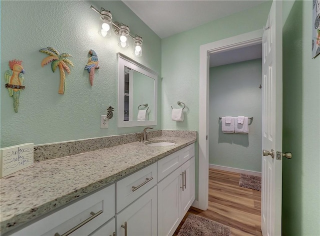 230 Cut Off Rd Unit 129, Port Aransas, TX 78373 - bathroom with vanity, wood finished floors, and baseboards