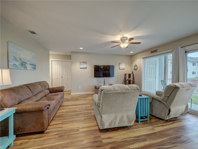 living room featuring ceiling fan and light hardwood / wood-style flooring