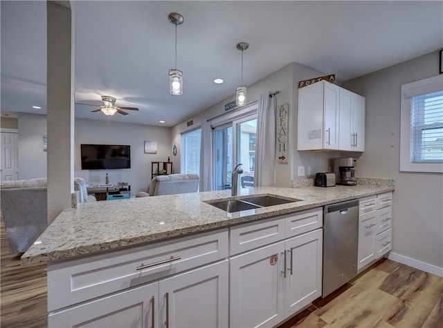 kitchen with sink, stainless steel dishwasher, ceiling fan, white cabinetry, and light hardwood / wood-style flooring