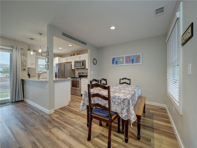 230 Cut Off Rd Unit 129, Port Aransas, TX 78373 - dining area featuring light wood finished floors, baseboards, and recessed lighting