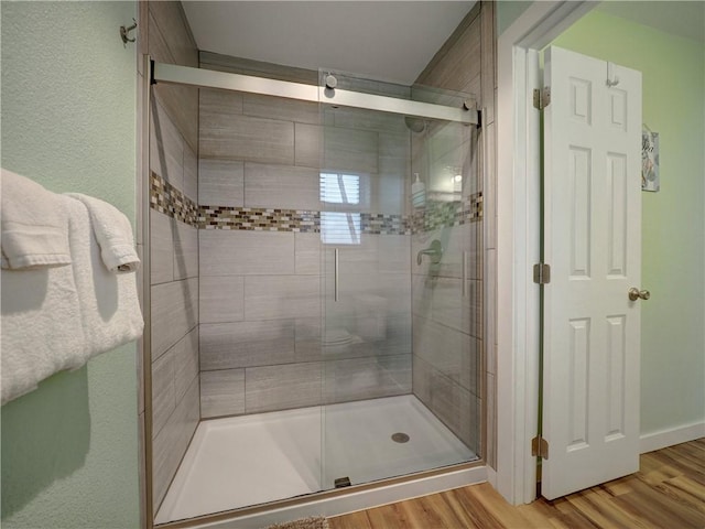 230 Cut Off Rd Unit 129, Port Aransas, TX 78373 - bathroom with a stall shower and wood finished floors