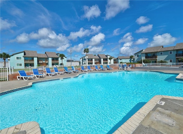 230 Cut Off Rd Unit 129, Port Aransas, TX 78373 - community pool featuring fence, a patio, and a residential view