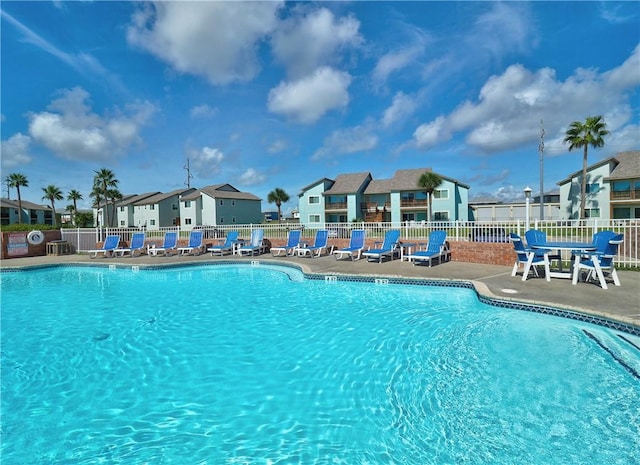230 Cut Off Rd Unit 129, Port Aransas, TX 78373 - community pool featuring fence, a patio area, and a residential view