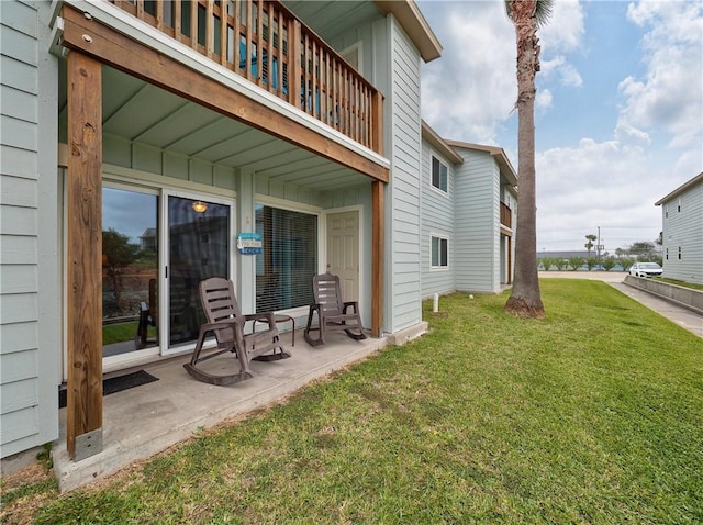 230 Cut Off Rd Unit 129, Port Aransas, TX 78373 - rear view of house with a balcony, a lawn, and a patio area