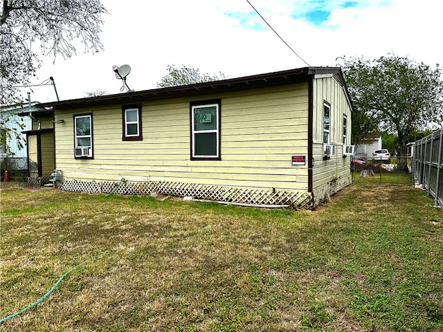 view of side of home featuring a lawn