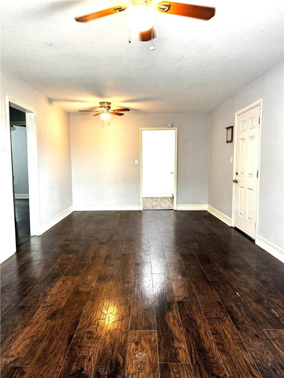 empty room featuring a textured ceiling and dark wood-type flooring