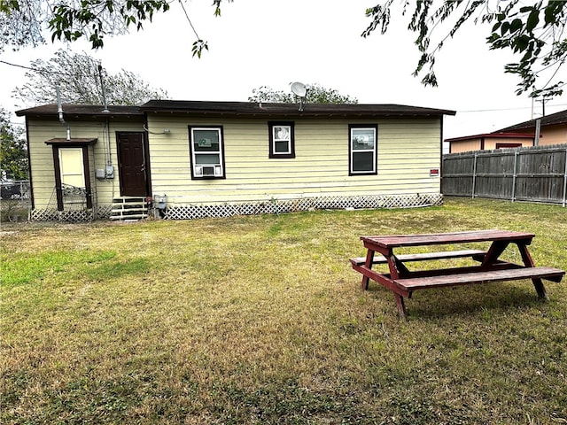 rear view of house with a lawn