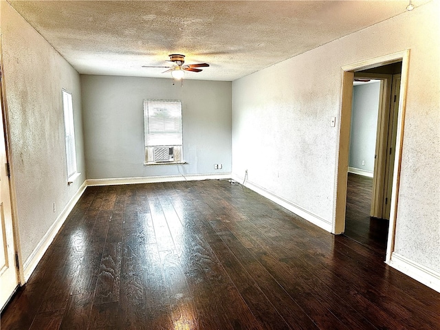 spare room with a textured ceiling, ceiling fan, cooling unit, and dark hardwood / wood-style floors