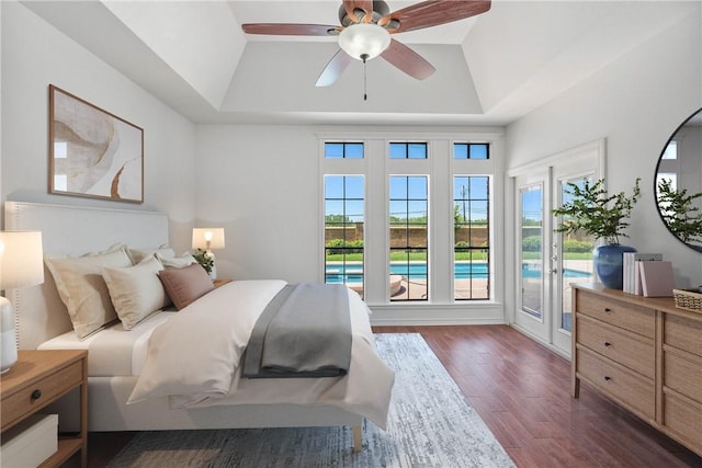 5913 Woodmere Dr, Corpus Christi, TX 78414 - bedroom with a raised ceiling, dark wood-style flooring, access to outside, and a ceiling fan