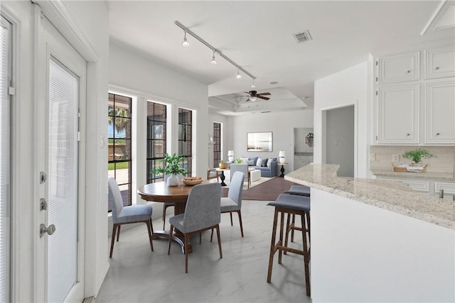 5913 Woodmere Dr, Corpus Christi, TX 78414 - dining room featuring rail lighting and ceiling fan
