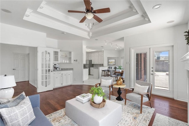 5913 Woodmere Dr, Corpus Christi, TX 78414 - living room with dark wood-style flooring, crown molding, ceiling fan, a tray ceiling, and rail lighting