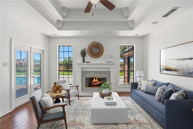 5913 Woodmere Dr, Corpus Christi, TX 78414 - living room featuring ornamental molding, a tray ceiling, hardwood / wood-style flooring, plenty of natural light, and a ceiling fan