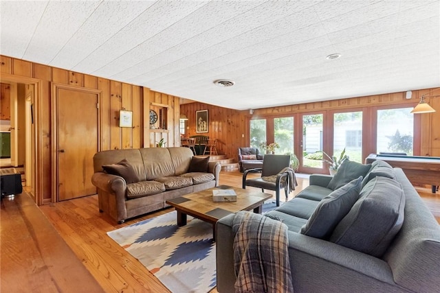 144 Cordula St, Corpus Christi, TX 78411 - living area with light wood-style floors and wood walls