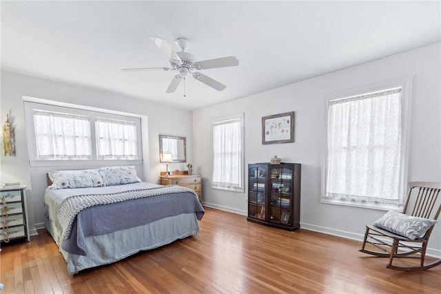 144 Cordula St, Corpus Christi, TX 78411 - bedroom with wood finished floors, baseboards, and a ceiling fan