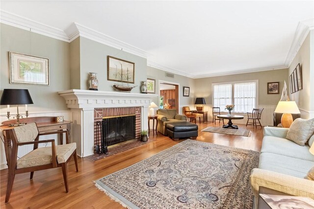 144 Cordula St, Corpus Christi, TX 78411 - living room featuring wood finished floors, ornamental molding, and a fireplace
