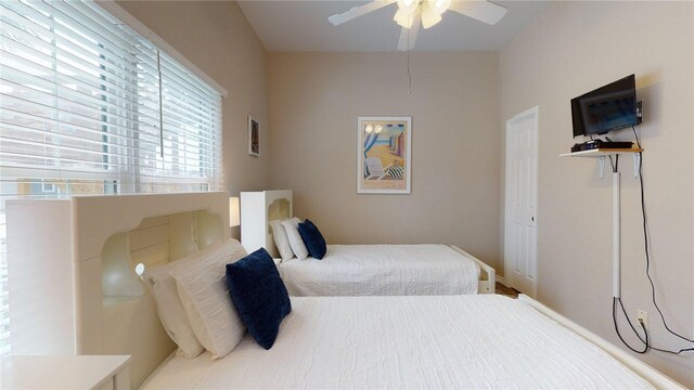 bedroom with baseboards and ceiling fan