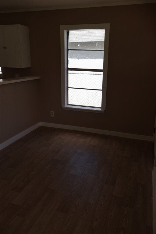 empty room featuring dark hardwood / wood-style flooring