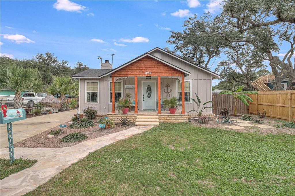 1032 N Magnolia St, Rockport, TX 78382 - bungalow with covered porch, a chimney, and board and batten siding