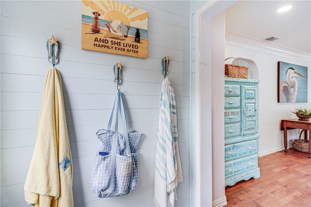 bathroom featuring hardwood / wood-style floors and crown molding