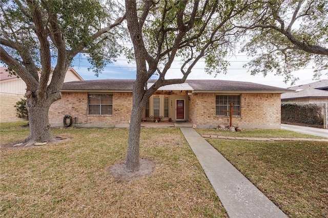 ranch-style home featuring brick siding and a front yard