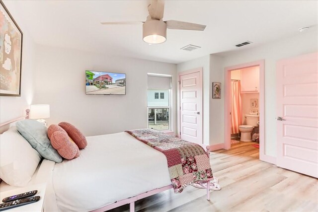 bedroom featuring a ceiling fan, connected bathroom, light wood-style flooring, and visible vents