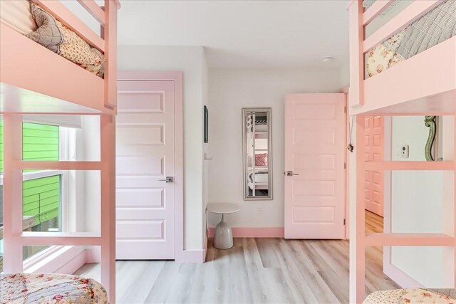 bedroom with baseboards and wood finished floors