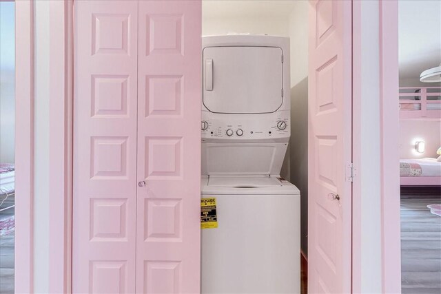 washroom with laundry area and stacked washing maching and dryer