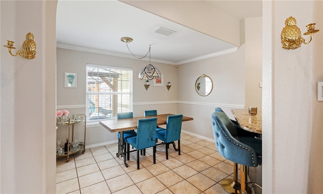 dining area featuring visible vents, crown molding, baseboards, and light tile patterned floors