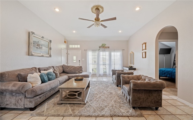 living room featuring arched walkways, ceiling fan, light tile patterned flooring, recessed lighting, and vaulted ceiling