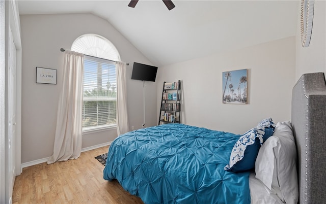 bedroom featuring lofted ceiling, ceiling fan, baseboards, and wood finished floors