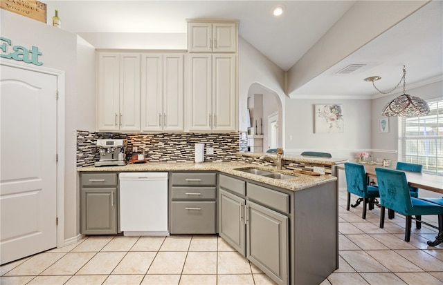 kitchen featuring gray cabinets, white dishwasher, a sink, and light tile patterned floors