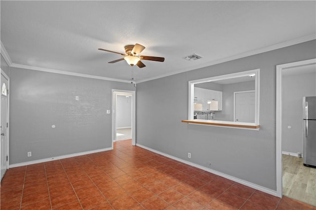 spare room featuring ornamental molding, tile patterned floors, and ceiling fan